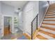 Inviting entryway with stylish staircase, modern door, neutral paint, tile flooring, and views to the yard at 327 S Turner Ave, Charlotte, NC 28208