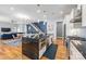 Open kitchen with stainless steel appliances, granite countertops, and a view of the modern living space at 327 S Turner Ave, Charlotte, NC 28208