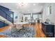 Modern kitchen features a round dining table, blue backsplash, white cabinetry, stainless appliances, and island seating at 327 S Turner Ave, Charlotte, NC 28208
