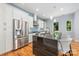 Well-equipped kitchen with stainless steel appliances, granite countertops, and a breakfast bar with modern pendant lighting at 327 S Turner Ave, Charlotte, NC 28208