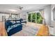Open-concept living area with hardwood floors, big windows, stylish decor, and seamless flow to the modern kitchen at 327 S Turner Ave, Charlotte, NC 28208