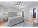 Spacious main bedroom with ample natural light, a king bed, and a walk-in closet for organized storage at 327 S Turner Ave, Charlotte, NC 28208
