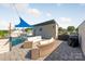 Inviting rooftop patio with wicker furniture and a grill, perfect for outdoor entertaining and relaxation at 327 S Turner Ave, Charlotte, NC 28208