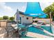 Rooftop patio complete with outdoor seating, a grill, and a shade umbrella for summer days at 327 S Turner Ave, Charlotte, NC 28208