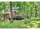 Brick house with deck and backyard lush green trees and landscaping at 3730 Monique Ln, Charlotte, NC 28210