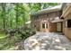 The backyard features a brick home, patio, and meticulously maintained greenery at 3730 Monique Ln, Charlotte, NC 28210
