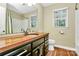 Bathroom featuring wood counters, stylish fixtures, and a large window for natural light at 3730 Monique Ln, Charlotte, NC 28210
