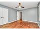 This bedroom features a neutral color palette, two closets, and hardwood floors at 3730 Monique Ln, Charlotte, NC 28210