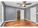 Bedroom featuring hardwood floors, a ceiling fan, and neutral gray walls at 3730 Monique Ln, Charlotte, NC 28210