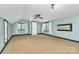Spacious carpeted bedroom with two windows, a ceiling fan, and neutral paint at 3730 Monique Ln, Charlotte, NC 28210