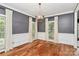Bright dining room boasts hardwood floors, large windows and an elegant chandelier at 3730 Monique Ln, Charlotte, NC 28210