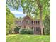 Charming brick two-story home with manicured lawn and lush greenery, enhancing its curb appeal at 3730 Monique Ln, Charlotte, NC 28210