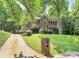 Charming brick two-story home featuring a red front door and a well-maintained lawn at 3730 Monique Ln, Charlotte, NC 28210
