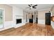 Spacious living room featuring a white brick fireplace, hardwood floors, and elegant trim at 3730 Monique Ln, Charlotte, NC 28210
