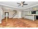 Open living room showcasing hardwood floors, staircase, and kitchen area with island at 3730 Monique Ln, Charlotte, NC 28210