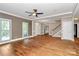 Open living room with hardwood floors, large windows, and staircase to upper level at 3730 Monique Ln, Charlotte, NC 28210