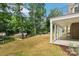 Lush backyard featuring a covered patio, a lake, and mature trees at 416 Plantation Way # 3, Mount Gilead, NC 27306