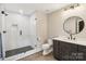 Modern bathroom with a glass-enclosed shower featuring white subway tile and a dark vanity at 416 Plantation Way # 3, Mount Gilead, NC 27306