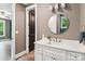 Bright bathroom with a white vanity, round mirror, and a view reflected in the mirror at 416 Plantation Way # 3, Mount Gilead, NC 27306