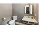 Powder room with marble countertop, gold fixtures, and toilet at 416 Plantation Way # 3, Mount Gilead, NC 27306