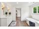 Bright bathroom featuring a soaking tub, vanity, modern fixtures, and wood-look floors at 416 Plantation Way # 3, Mount Gilead, NC 27306