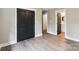 Bedroom with woodgrain flooring, double closet doors, and doorway to a bathroom at 416 Plantation Way # 3, Mount Gilead, NC 27306