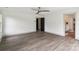 Spacious bedroom featuring wood-look floors, neutral walls, and access to an ensuite bathroom at 416 Plantation Way # 3, Mount Gilead, NC 27306