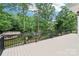 Large deck overlooking a serene lake, surrounded by lush trees and offering picturesque views at 416 Plantation Way # 3, Mount Gilead, NC 27306