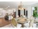 Dining room featuring table with chairs and decorative light fixture in view of the kitchen at 416 Plantation Way # 3, Mount Gilead, NC 27306