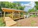 Picturesque view of a wooden boat dock on a tranquil lake setting surrounded by trees at 416 Plantation Way # 3, Mount Gilead, NC 27306