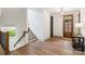 Hallway with hardwood floors leading to the staircase and the entryway at 416 Plantation Way # 3, Mount Gilead, NC 27306