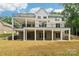 Rear exterior view of a multi-level home with balconies and a spacious backyard at 416 Plantation Way # 3, Mount Gilead, NC 27306