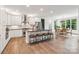 Well-lit kitchen with a center island, white cabinets, and stainless-steel appliances at 416 Plantation Way # 3, Mount Gilead, NC 27306