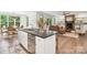 Open concept kitchen with stainless steel appliances, granite counters, island and view of fireplace and living area at 416 Plantation Way # 3, Mount Gilead, NC 27306