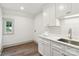 Bright laundry room featuring white cabinets, sink, and a window with natural light at 416 Plantation Way # 3, Mount Gilead, NC 27306