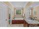 Bathroom featuring a soaking tub with tile surround, and a vanity with stone countertop at 4263 Rambling Rose Ln # 23, Rock Hill, SC 29732