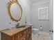 Powder room boasts decorative mirror, detailed vanity, neutral paint, and tile flooring at 4263 Rambling Rose Ln # 23, Rock Hill, SC 29732