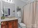 Bright bathroom featuring stone countertop vanity, silver hardware and a shower with curtain at 4263 Rambling Rose Ln # 23, Rock Hill, SC 29732