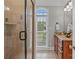 A well-lit bathroom featuring a glass enclosed shower, vanity, and natural light from a window at 4263 Rambling Rose Ln # 23, Rock Hill, SC 29732