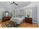 Bedroom featuring tray ceiling, natural lighting, and wood floor at 4263 Rambling Rose Ln # 23, Rock Hill, SC 29732