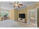 Bright bedroom features a desk area, ceiling fan, and neutral carpet at 4263 Rambling Rose Ln # 23, Rock Hill, SC 29732