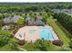 Aerial view of the community pool and clubhouse with lounge chairs and picnic tables at 4263 Rambling Rose Ln # 23, Rock Hill, SC 29732