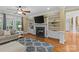 Well-lit living room with fireplace, built-in shelving, and hardwood floors at 4263 Rambling Rose Ln # 23, Rock Hill, SC 29732