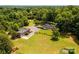 Aerial view featuring the house, detached garage, and lush green surroundings at 4275 Herman Sipe Rd, Conover, NC 28613