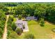 Aerial view showcasing the house, detached garage, and surrounding greenery at 4275 Herman Sipe Rd, Conover, NC 28613