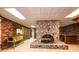 Basement features stone fireplace, brick wall, wet bar, and a vintage pinball machine at 4275 Herman Sipe Rd, Conover, NC 28613