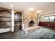 Basement featuring a large stone fireplace, vintage built-in shelving, and an arched doorway at 4275 Herman Sipe Rd, Conover, NC 28613