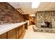 Spacious basement featuring a stone fireplace, wet bar, brick walls, and a staircase to upper level at 4275 Herman Sipe Rd, Conover, NC 28613