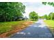 Sprawling property with a long driveway leading to a stone-clad house and a detached three-car garage at 4275 Herman Sipe Rd, Conover, NC 28613