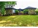 Charming stone-clad house featuring a lush front lawn, mature trees, and brick steps leading to the entrance at 4275 Herman Sipe Rd, Conover, NC 28613